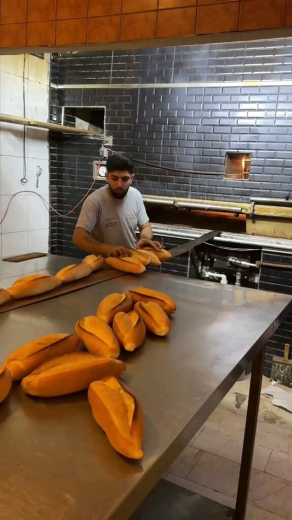 The lines of bread this man pulls out of the oven