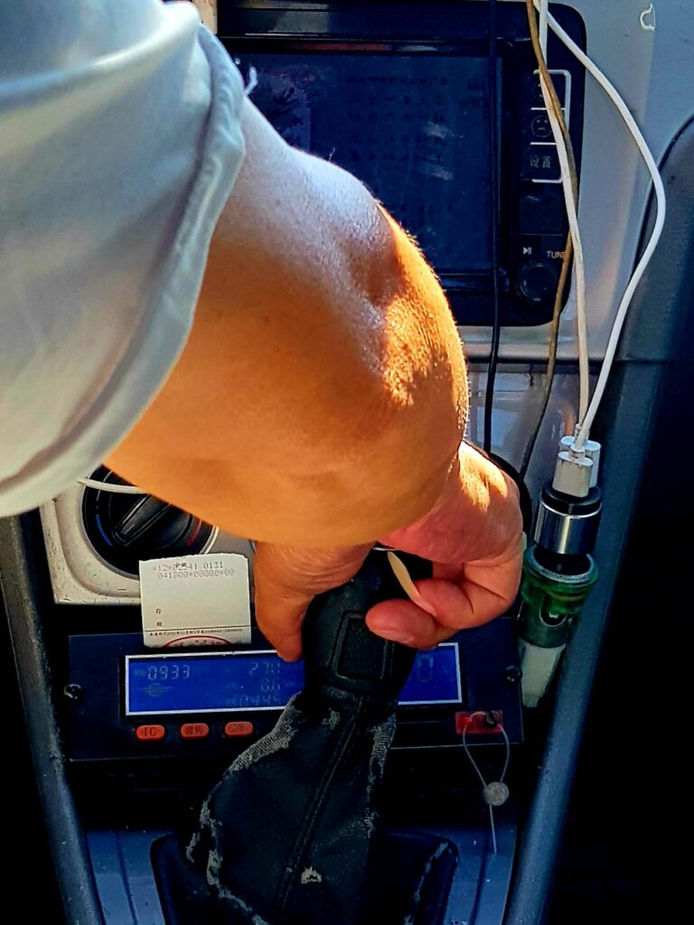 The long pinky nail of this Chinese taxi driver