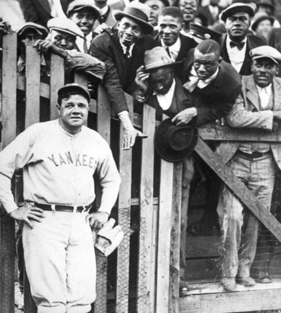 Babe Ruth posing with fans 1925. He was a popular figure in the African American community because of his willingness to treat them as he would white …