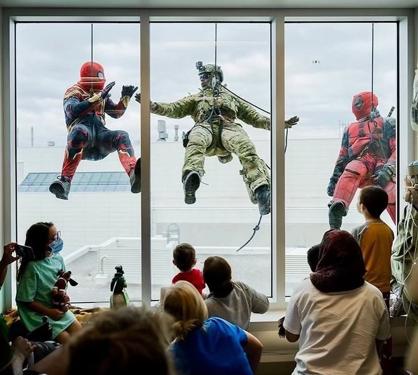 Tactical team personnel dressed up as Spiderman and Deadpool rappel down the walls of the Montreal Children’s Hospital