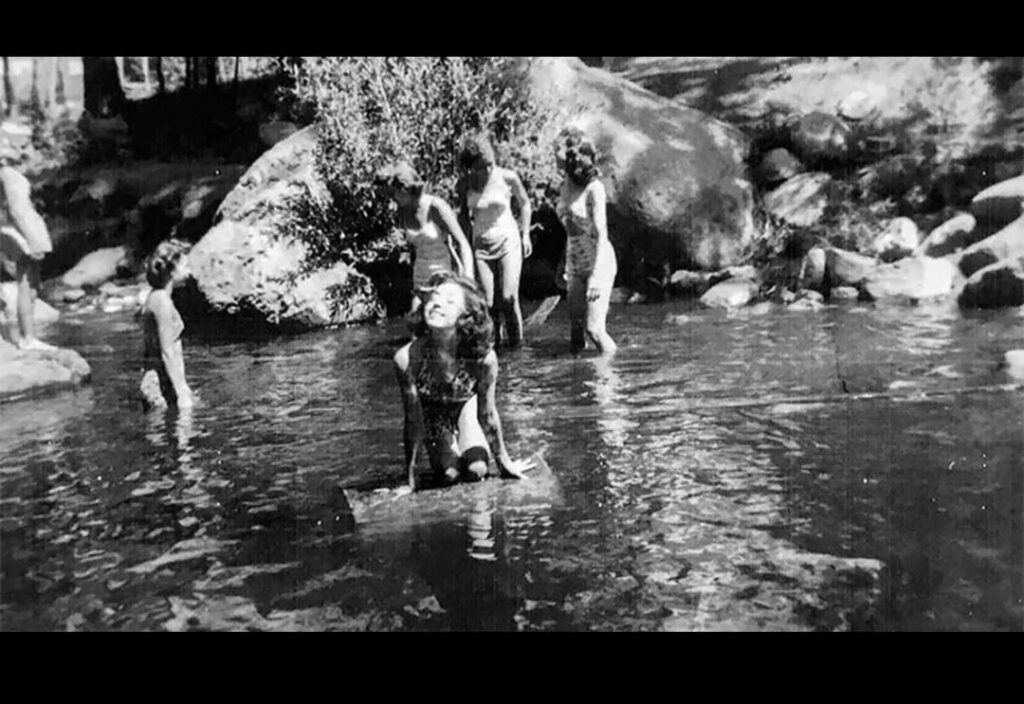 13-year-old Barbara Kent (center) and her fellow campers play in a river near Ruidoso, New Mexico, on July 16, 1945, just hours after the Atomic Bomb …