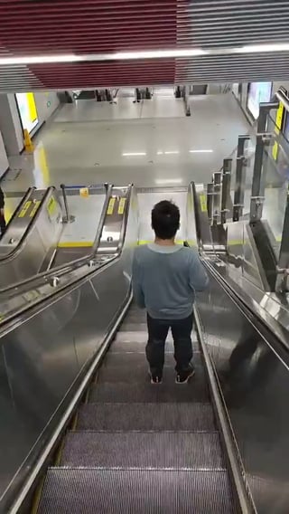 Man shows how far down he has to go to get to work in Chongqing, China