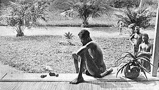 This is a photo of a rubber worker in the Belgian Congo staring at the severed hands and feet of his five-year-old daughter. She was murdered because …