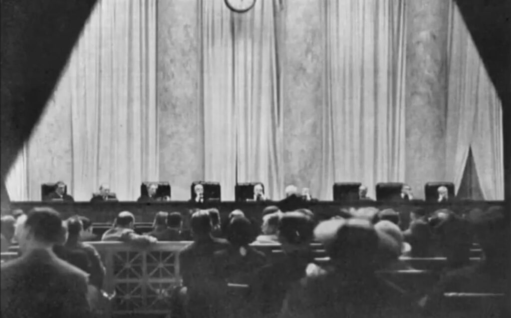 One of two photographs in existence of the US Supreme Court in session. Taken by a young women who cut a hole in her handbag through which the lens pe…